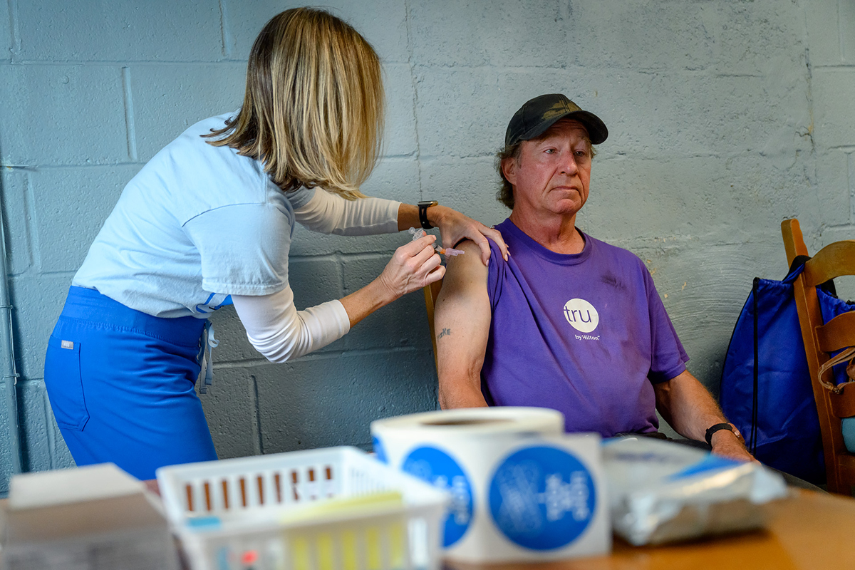 Tracy Mifflin, left, a registered nursed in MTSU Health Services, administers the one-shot Johnson & Johnson COVID-19 vaccine to Mike Revoir during a special two-hour vaccine event at Journey Home Inc. in Murfreesboro. Journey Home is a Christian ministry that serves homeless people and the disadvantaged. (MTSU photo by J. Intintoli)
