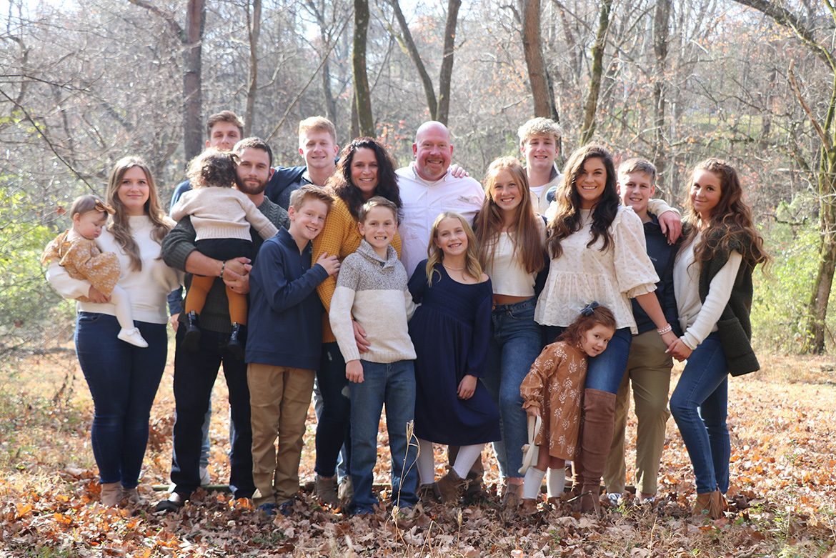 MTSU adult learner Julie Witt of Old Hickory, Tenn., center left in yellow sweater, and her husband, Joshua, next to her in white shirt, are shown in this family portrait with their children and grandchildren. Julie Witt takes online courses through University College in pursuit of her bachelor’s degree in integrated studies after two decades away from the classroom. She’s on track to graduate in May 2022. (Submitted photo)