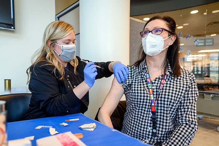 In this March file photo, MTSU Health Services nurse practitioner Kendra Todd, left, administers the Moderna vaccine to Andrea Sakoff, a secretary in Murphy Center, in the Health, Wellness and Recreation Center. Health Services continues offering COVID-19 vaccination clinics to serve MTSU faculty, staff, students and retirees during CUSTOMS new student orientation sessions this summer. (MTSU file photo by J. Intintoli)