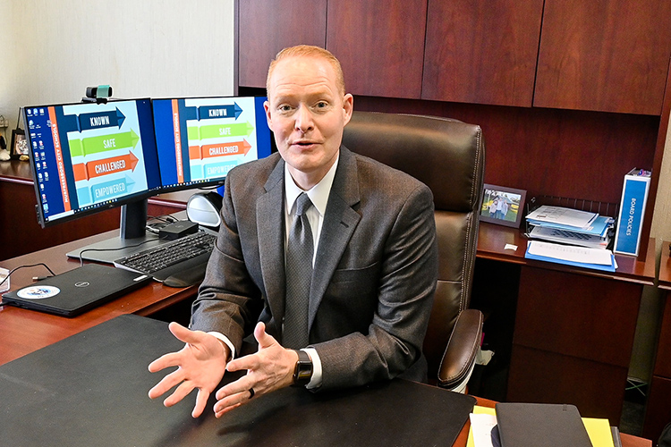 New Murfreesboro City Schools Director Trey Duke, who recently earned his third degree from Middle Tennessee State University in May, explains how MCS is proud to have MTSU graduates as part of their school district family in his office on March 11, 2021. (MTSU photo by Stephanie Barrette)