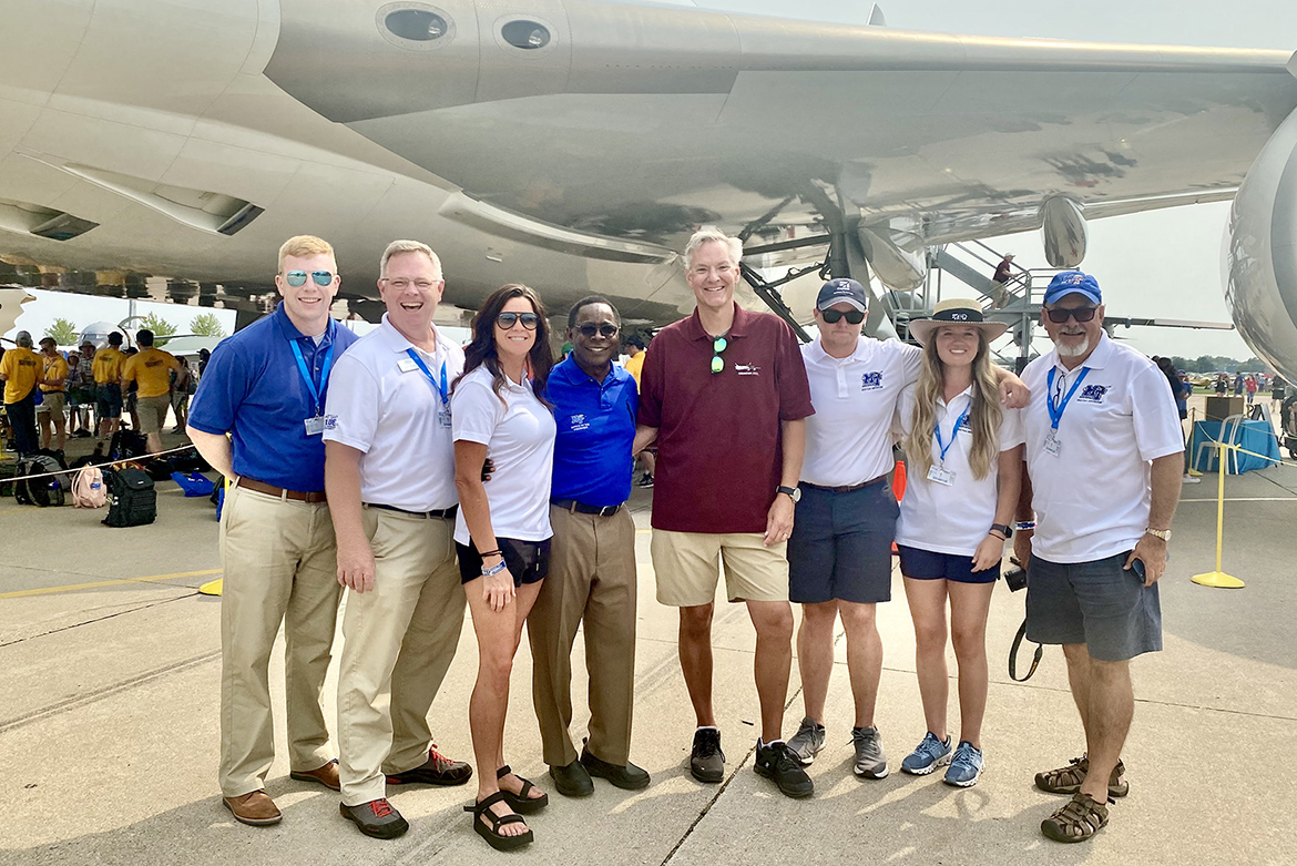MTSU President Sidney A. McPhee, fourth from left, and to his right, Mike Starnes, a captain with United Parcel Service and an aerospace alumnus, pose with MTSU staff and students in front of the brand-new UPS 747 that Starnes flew to the EAA AirVenture 2021 air show held July 26-Aug. 1 in Oshkosh, Wisc. (MTSU photo by Andrew Oppmann)