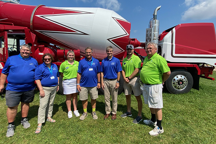 MTSU Provost Mark Byrnes, fourth from left, and Greg Van Patten, interim dean of the College of Basic and Applied Sciences, third from right, meet with officials from the Oshkosh Corp. at the EAA AirVenture air show in Oshkosh, Wisc., on behalf of MTSU’s School of Concrete and Construction Management. The corporation, which makes concrete trucks and other heavy equipment, had a presence at the air show, held July 26-Aug. 1. (MTSU photo by Andrew Oppmann)