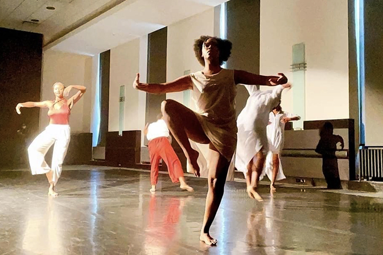 MTSU dance alumna Jordyn Hill, center, and professor Jade Treadwell, left, concentrate on their performance Saturday, July 24, in the auditorium at Nashville's Frist Art Museum while their fellow MTSU dancers strike poses behind them. The five-member troupe presented "Visceral Undercurrent," a dance routine Treadwell choreographed that was inspired by "Cut to the Quick," a new exhibition at the Frist of artist Kara Walker's works of social and personal commentary. (photo courtesy of the Frist Art Museum)