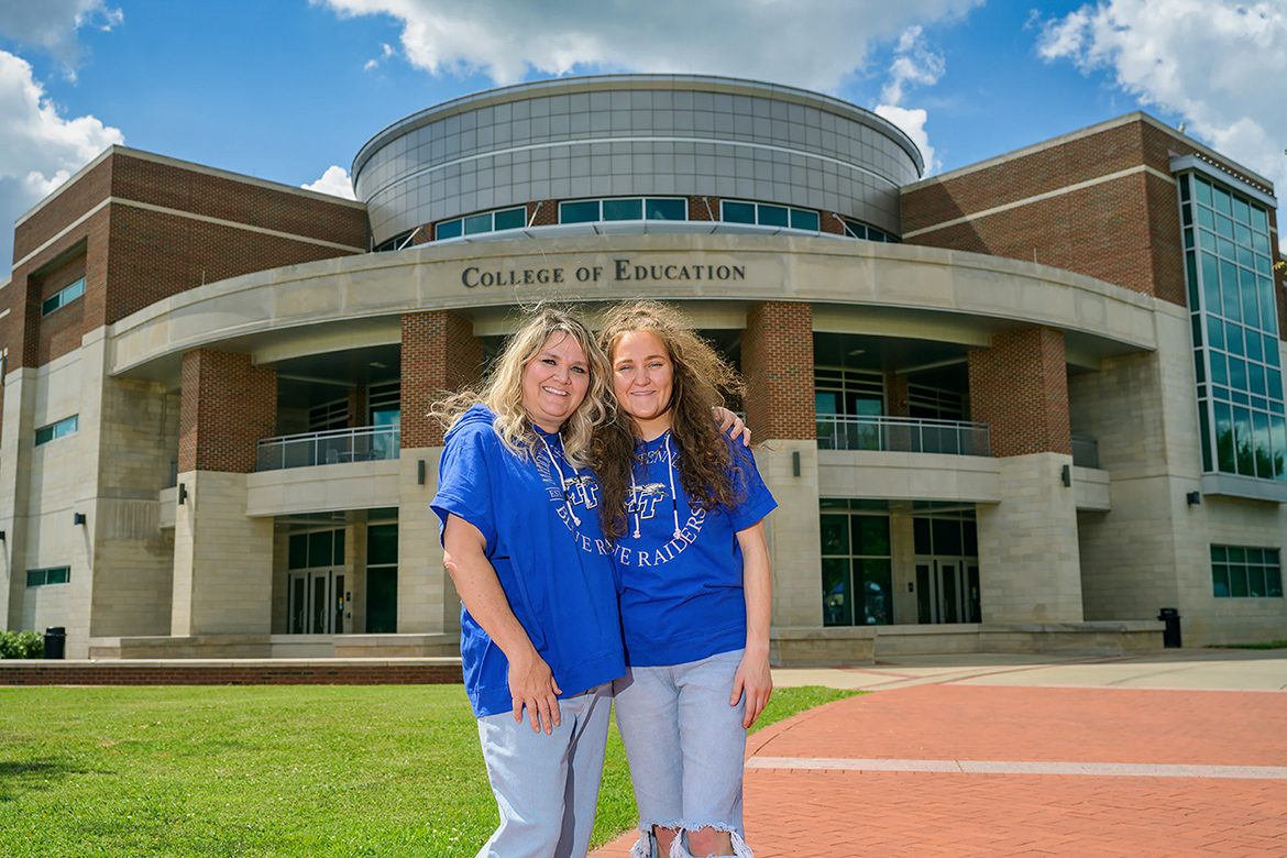 Gretchen Solomon, Middle Tennessee State University education alumna, left, and MTSU education student Leah Solomon pose in front of the university’s College of Education on June 30, 2021, where Leah followed her mother’s footsteps into the world of early childhood special education. (MTSU photo by Andy Heidt)