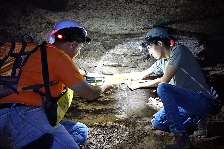 Mark Abolins, Middle Tennessee State University geosciences professor, left, and Mark Olivera, MTSU undergraduate student, right, conducted research inside of Snail Shell Cave in Rockvale, Tenn., in July 2018. (Photo courtesy of Josh Upham)