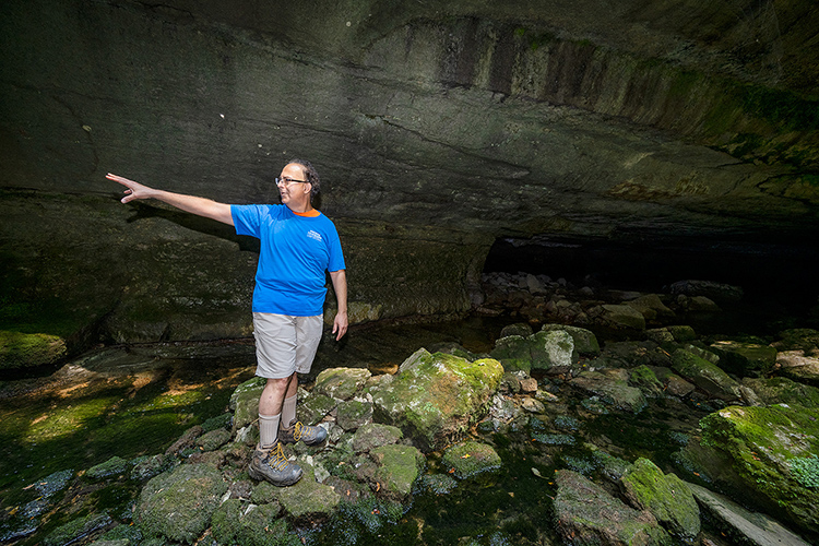Mark Abolins, Middle Tennessee State University geosciences professor, talks about Snail Shell Cave while hiking inside the cave system in Rockvale, Tenn., on July 23, 2021. (MTSU photo by Andy Heidt)
