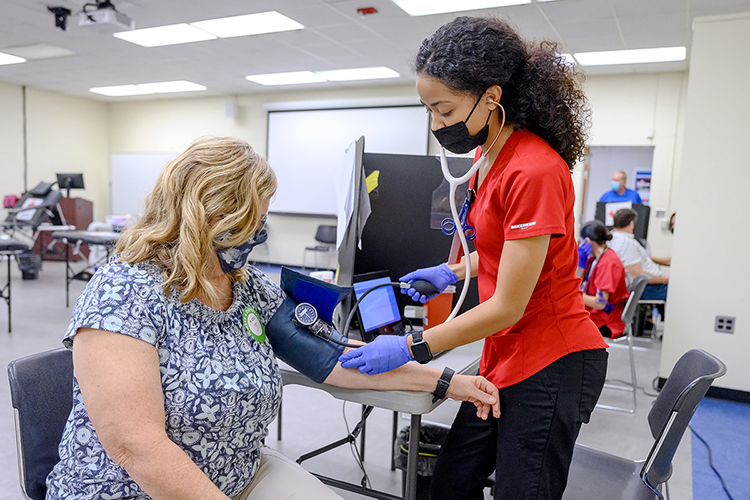 MTSU School of Nursing secretary Kim Floyd-Tune, left, watches as American Red Cross phlebotomist Marielys Rodriguez carefully checks her blood pressure before Floyd-Tune donates a pint of blood at the university's annual “Battle of the Branches” blood drive Sept. 2 in the Keathley University Center. Donors from across the campus and surrounding community gave 80 pints of blood to help as many as 225 people across the region and state. (MTSU photo by J. Intintoli)