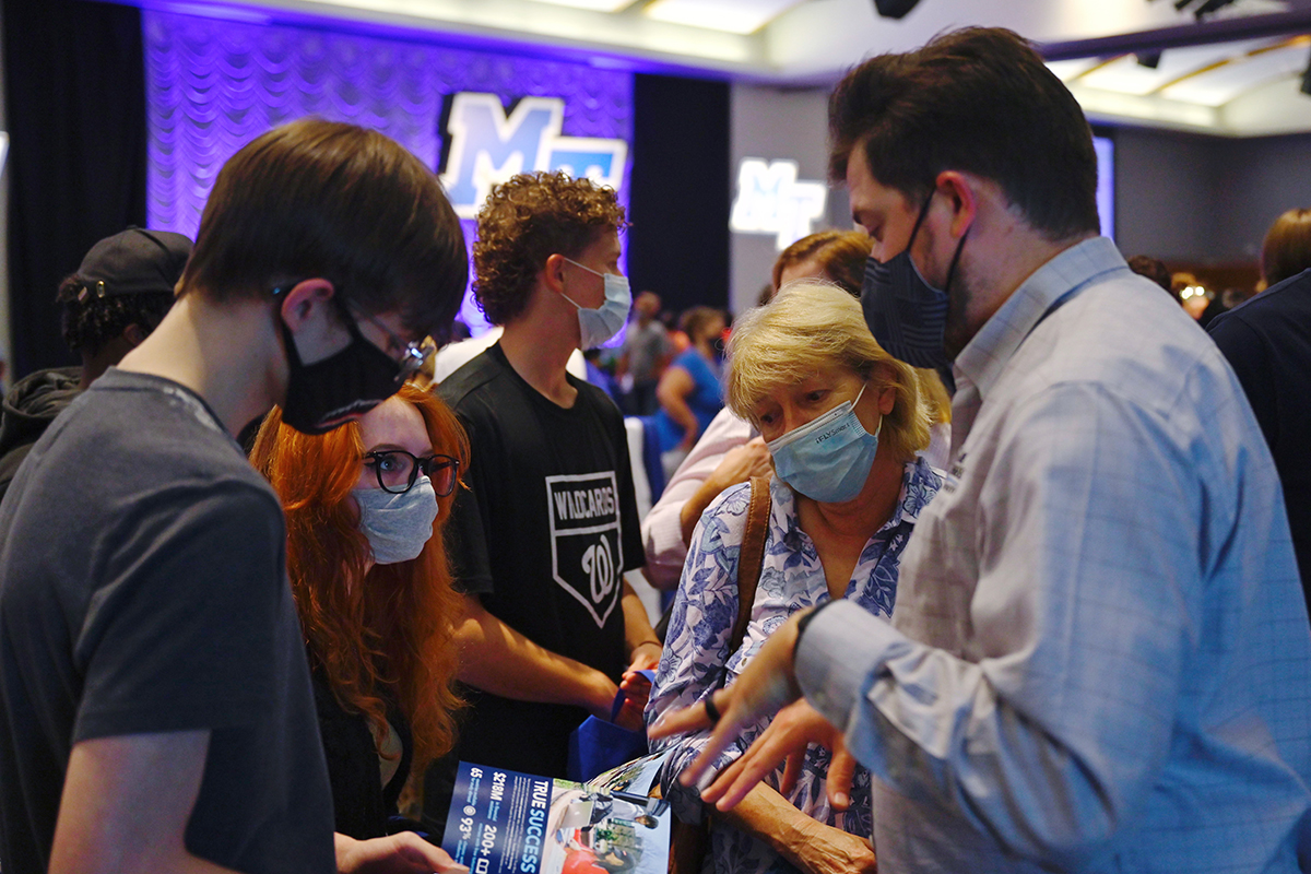 An MTSU adviser assists prospective students by providing information and answering their questions during a recent recruiting event in the MTSU Student Union Ballroom. More than 50 colleges will attend the annual Rutherford County College Night, hosted by MTSU, from 6 to 8 p.m. Wednesday, Sept. 8. All attendees will be required to wear masks in accordance with COVID-19 protocols. (MTSU file photo by Cat Curtis Murphy)