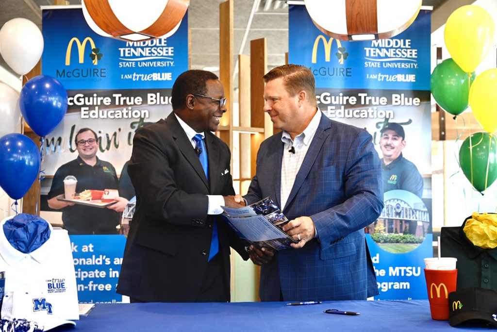 MTSU President Sidney A. McPhee, left, and McGuire Management Group owner/operator Jonathon McGuire shake hands after signing the McGuire True Blue Education Partnership MOU Wednesday, Aug. 4, 2021, at the McDonald’s franchise on Memorial Boulevard. The agreement calls for McGuire employees to attend MTSU tuition-free if they meet qualifying criteria. (MTSU photo by J. Intintoli)