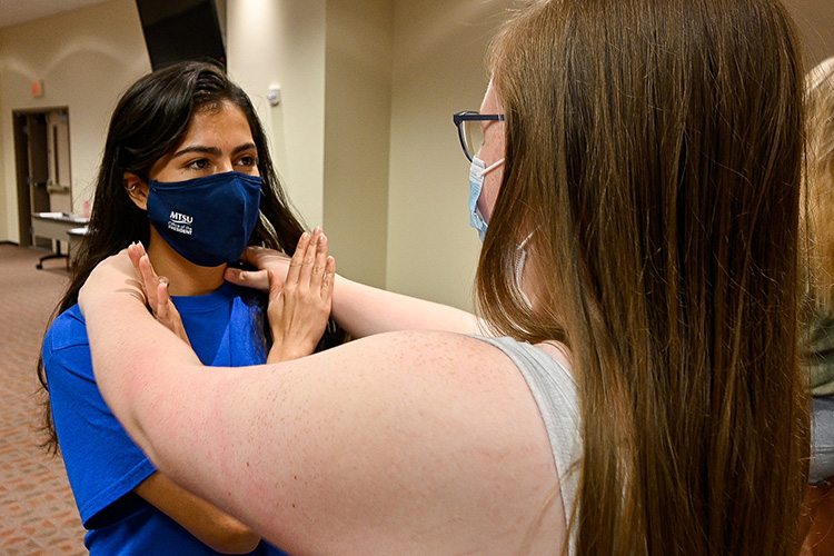 Gaby Jaimes, Middle Tennessee State University student, left, practices defending against an attack from her partner Savannah Winegar, another MTSU student, as part of the free self-defense course Rape Aggression Defense Systems, or RAD, that began on Sept. 7, 2021 (MTSU photo by Stephanie Barrette)