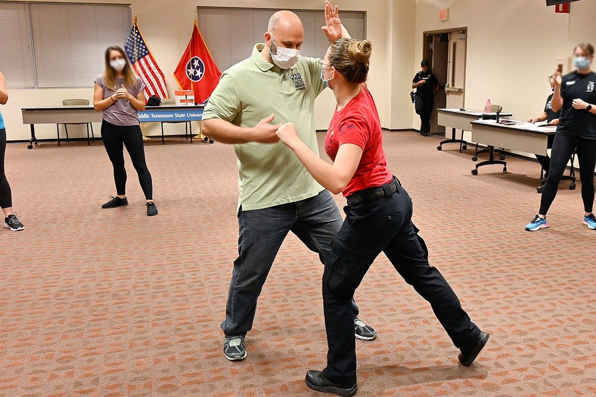 Jason Hurley, Middle Tennessee State University training sergeant, models deflecting an attack with Katelynn Erskine, MTSU police officer, as part of the self-defense course Rape Aggression Defense Systems, or RAD, offered free of charge on Sept. 7, 2021. (MTSU photo by Stephanie Barrette)