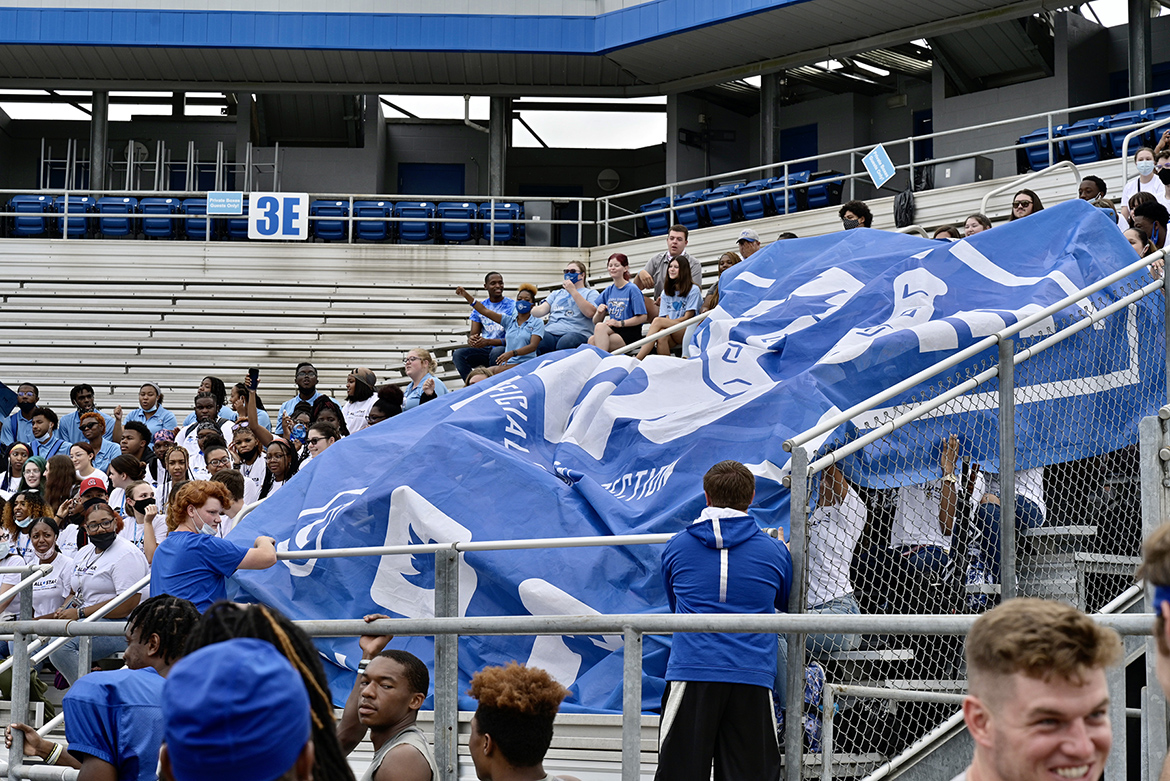 A group of MTSU students unfurl the giant Blue Zoo banner for the first time in two years on Thursday, Aug. 19, inside Floyd Stadium in preparation for the upcoming football season. (MTSU photo by Andy Heidt)