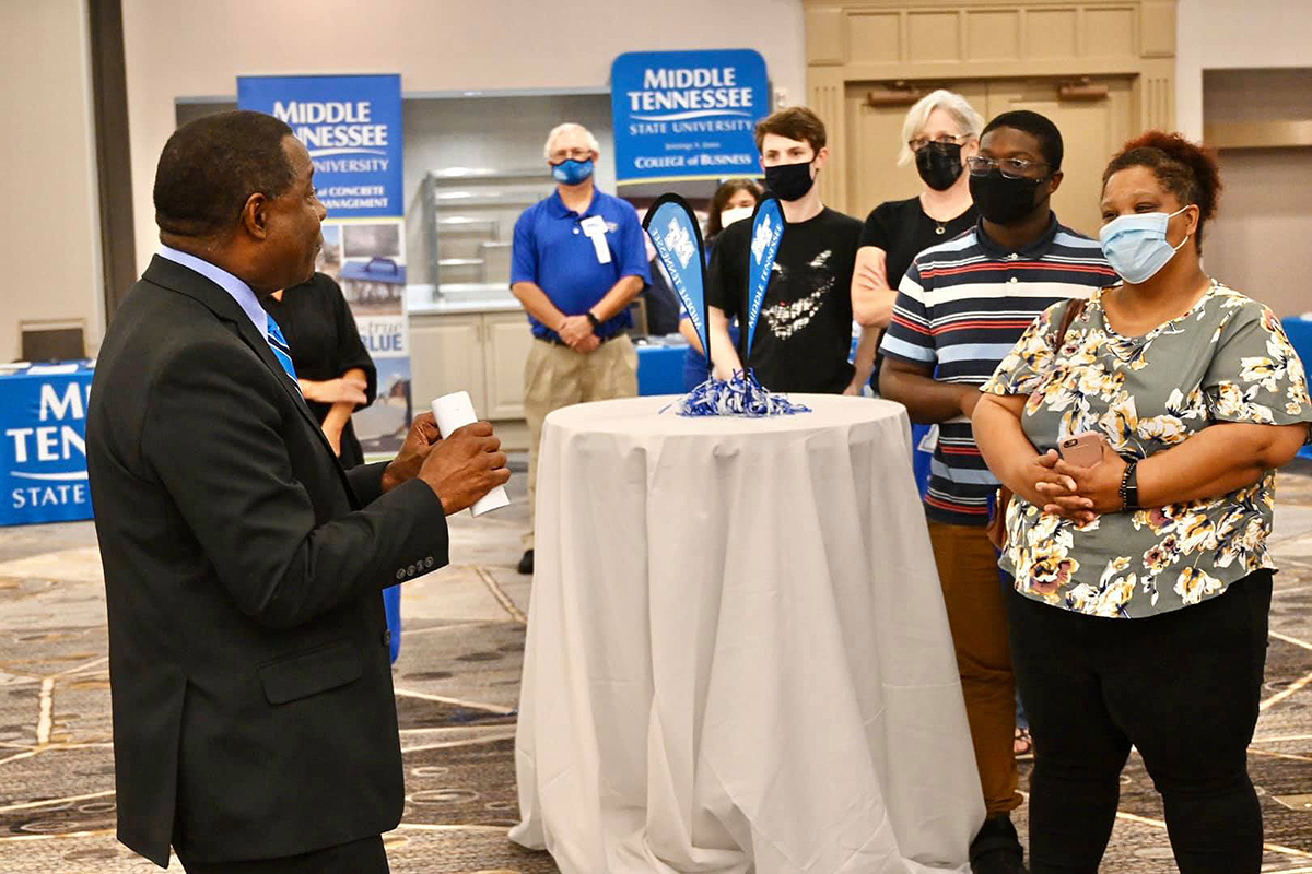 MTSU President Sidney A. McPhee, left, visits with prospective students and their parents attending the True Blue Tour event at the Marriott Birmingham in Hoover, Ala., Tuesday, Sept. 21. Listening are Jennifer Davis, right, her son Christian Davis, of Hoover, and Leigh Ann Harris and her son, Nathan Harris, of Chelsea, Ala. McPhee awarded Davis, Harris, Kyla Fulton of Pelham, Ala., and Jordan Gunter of Vestavia Hills, Ala., $2,000 scholarships. (MTSU photo by Andrew Oppmann)