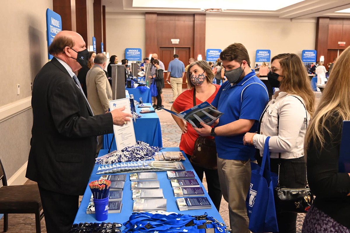 MTSU Jones College of Business Dean David Urban, left, provides helpful information to prospective students and their family members Wednesday, Sept. 22, at the True Blue Tour event at The Westin Huntsville in Huntsville, Ala. Students from area high schools attended the event, which featured scholarship giveaways, a video about campus and information about housing, financial aid and academic programs. (MTSU photo by Andrew Oppmann)