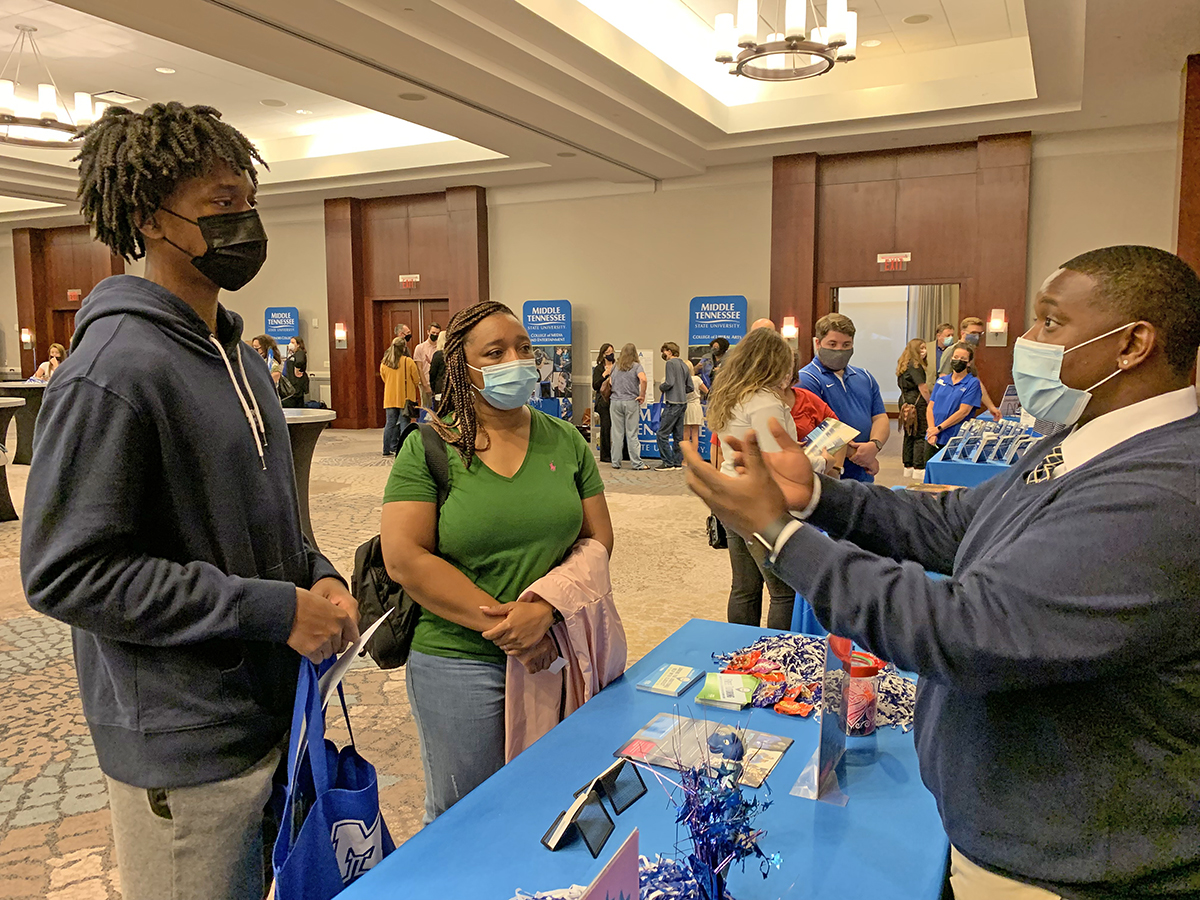 Tim Clark Jr., left, a senior at Westminister High School in Huntsville, Ala., and his mother, Wykeisa Clark, listen as Travis Strattion, provides information about the MTSU Office of Student Success Wednesday, Sept. 22, during the True Blue Tour stop in Huntsville. MTSU visits 14 cities in four states in its effort to recruit new students. (MTSU photo by Randy Weiler)