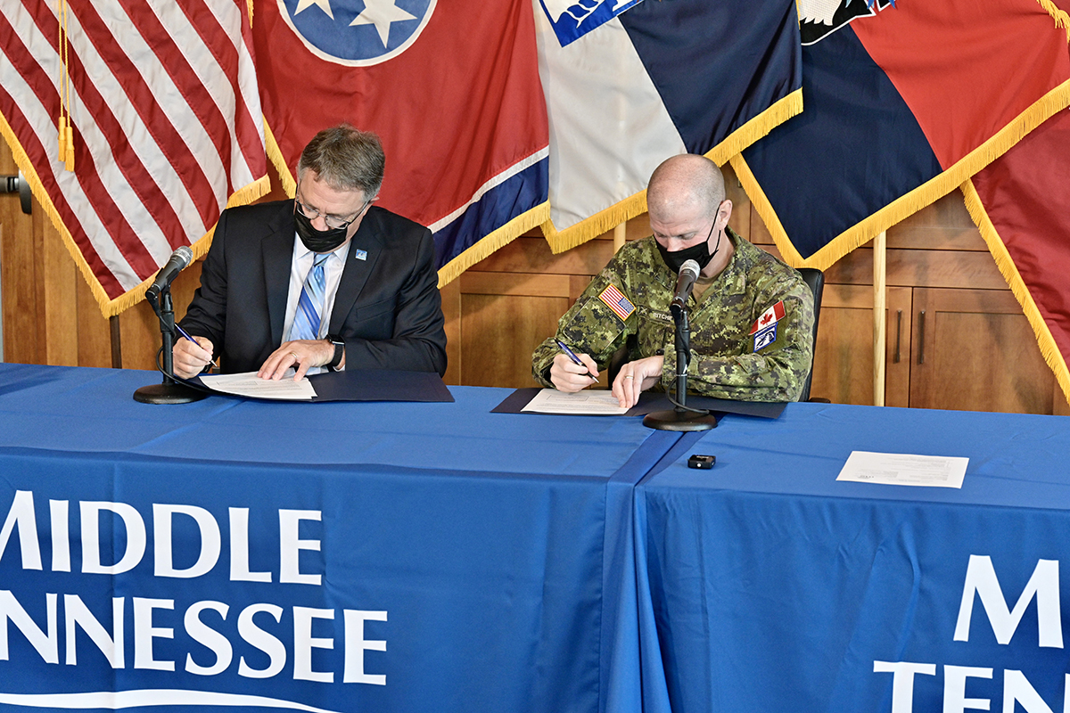 University Provost Mark Byrnes, left, and U.S. Army Brig. Gen. Bob Ritchie, right, sign the educational partnership agreement between MTSU and the XVIII Airborne Corps Wednesday, Sept. 8, in the Student Union Building Executive Conference Room. The partnership will encourage education, research and innovation collaboration in the STEM fields and other disciplines. (MTSU photo by Andy Heidt)