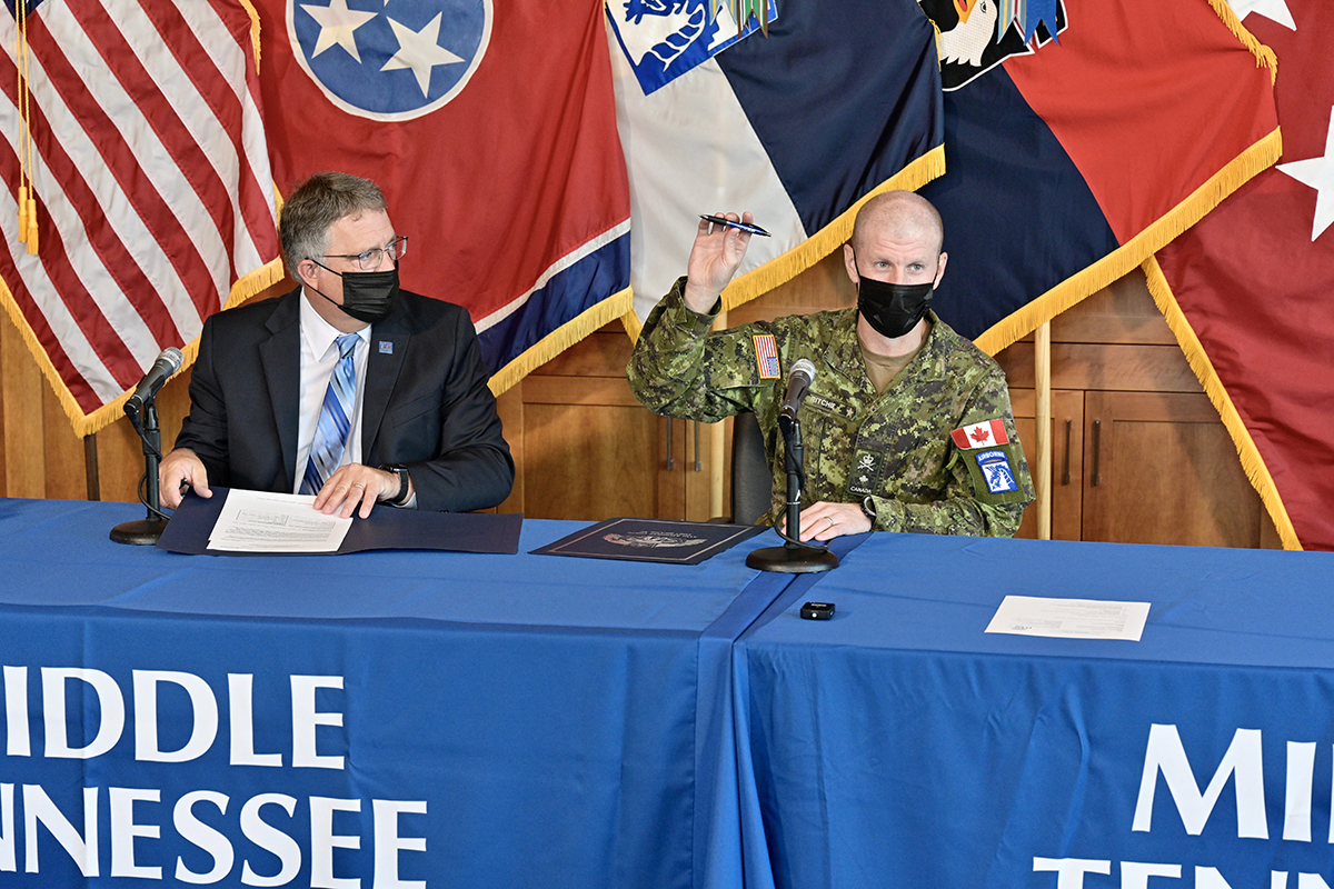 U.S. Army Brig. Gen. Bob Ritchie, right, and MTSU Provost Mark Byrnes enjoy a light moment regarding the university pen Ritchie used to sign the educational partnership agreement Wednesday, Sept. 8, in the Student Union Building Executive Conference Room. The partnership will encourage education, research and innovation collaboration in the STEM fields and other disciplines. (MTSU photo by Andy Heidt)