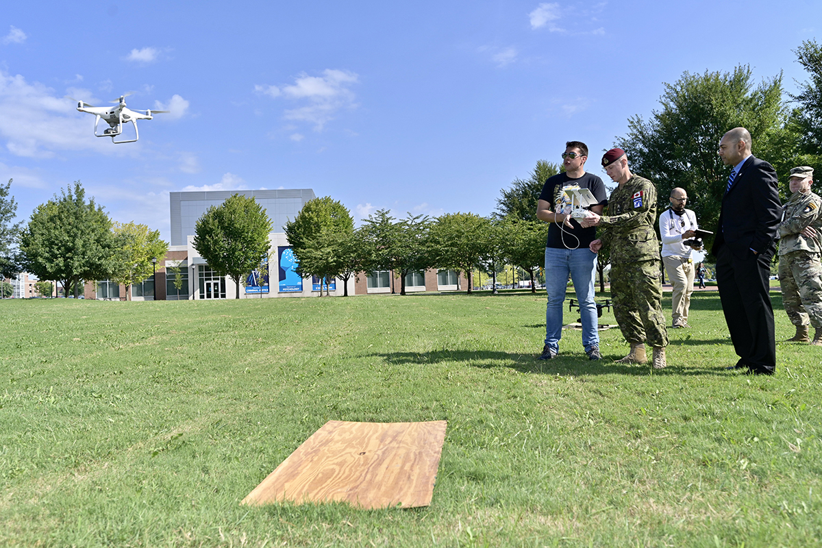 MTSU aerospace unmanned aircraft systems senior Corwin Cordell of Chattanooga, Tenn., offers U.S. Army Brig. Gen. Bob Ritchie pointers in flying a drone as Chaminda Prelis, first-year Aerospace Department chair, watches. Officials with the Army’s 101st and XVIII Airborne Divisions signed and educational partnership agreement Wednesday, Sept. 8, to promote collaboration in the STEM fields and innovation. (MTSU photo by Andy Heidt)