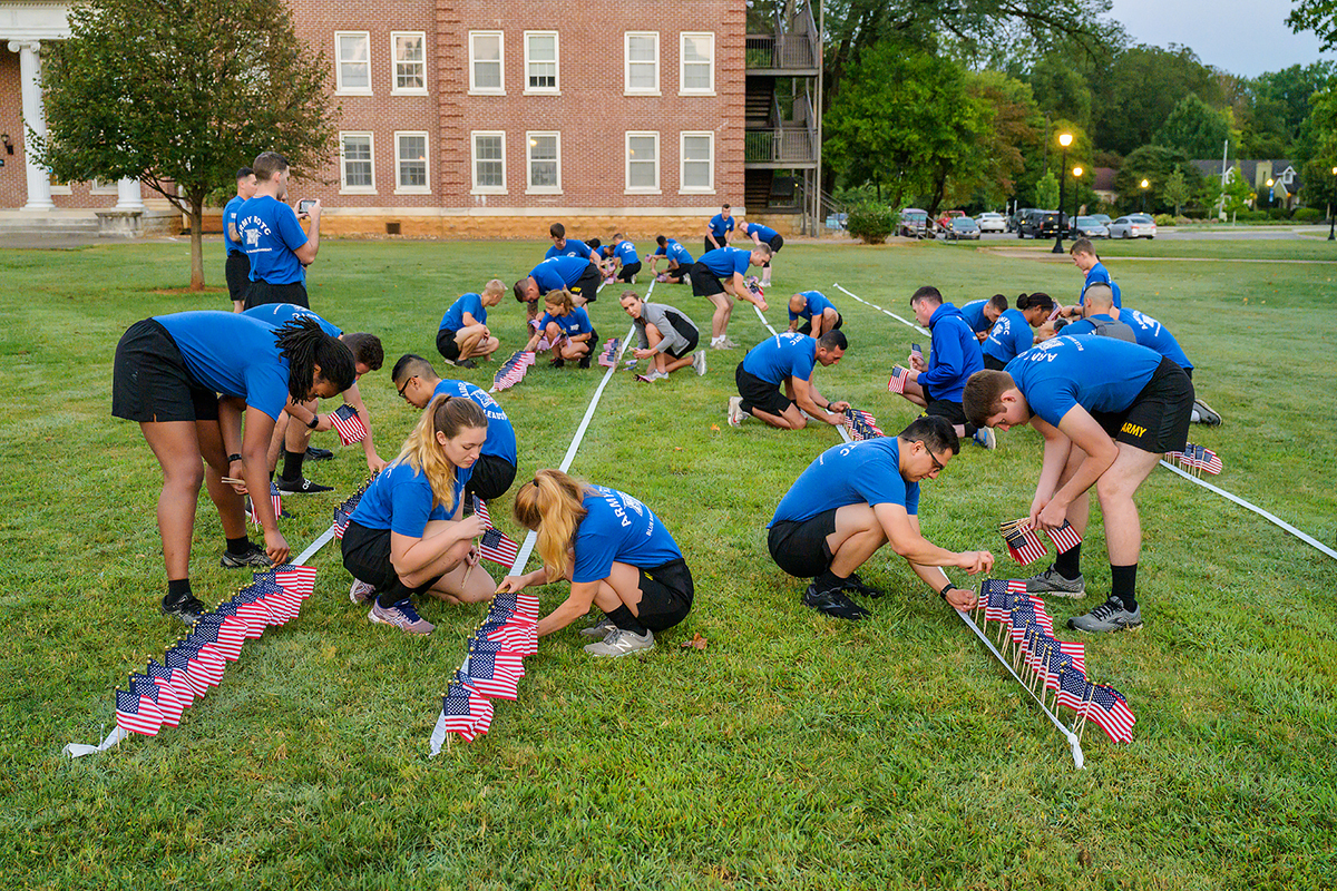 MTSU ROTC cadets, faculty and other volunteers place a portion of nearly 3,000 small U.S. flags in an area near the MTSU Veterans Memorial and Tom H. Jackson Building just after 6 a.m. Friday, Sept. 10. The cadet-led project commemorated the 20th anniversary of 9/11. (MTSU photo by Andy Heidt)