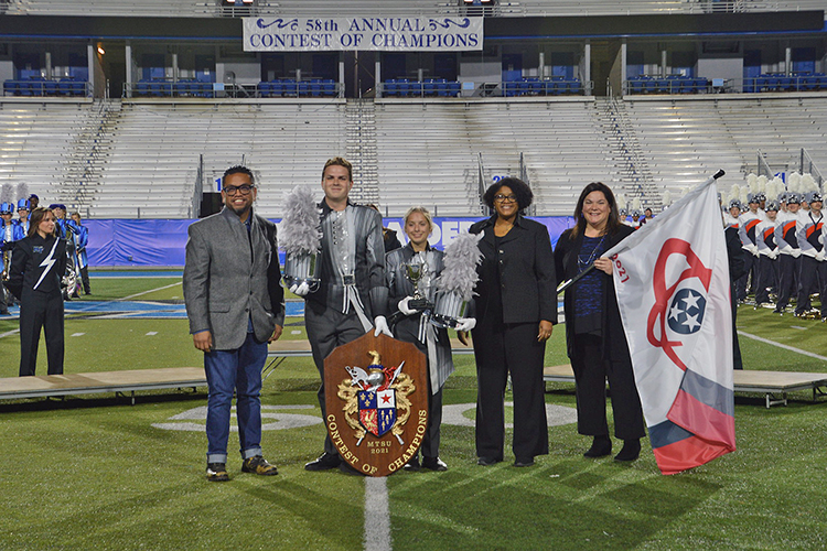 Pope High School of Marietta, Ga., took home the grand champion prize for their performance at the 58th Contest of Champions held Saturday, Oct. 23, at Floyd Stadium. Presenting the band with their awards are, far right, Jennifer Vannatta-Hall, interim director of the MTSU School of Music, and next to her, Leah Lyons, interim dean of the MTSU College of Liberal Arts. At left is Henry Go from Innovative Percussion. (Submitted photo)