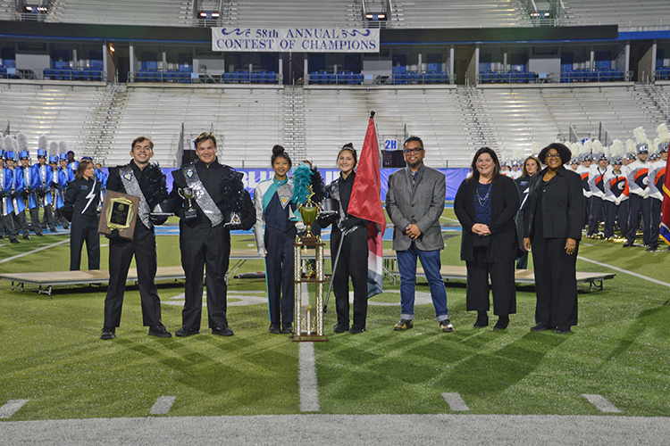The Seigel High School Marching Band of Murfreesboro, Tenn., took home the reserve champion prize for their performance at the 58th Contest of Champions held Saturday, Oct. 23, at Floyd Stadium. Presenting the band with their awards are, from right, Leah Lyons, interim dean of the MTSU College of Liberal Arts, Jennifer Vannatta-Hall, interim director of the MTSU School of Music, and Pope High School of Marietta, Ga., took home the grand champion prize for their performance at the 58th Contest of Champions held Saturday, Oct. 23, at Floyd Stadium. Presenting the band with their awards are, far right, Jennifer Vannatta-Hall, interim director of the MTSU School of Music, and next to her, Leah Lyons, interim dean of the MTSU College of Liberal Arts. At left is Henry Go from Innovative Percussion. (Submitted photo)