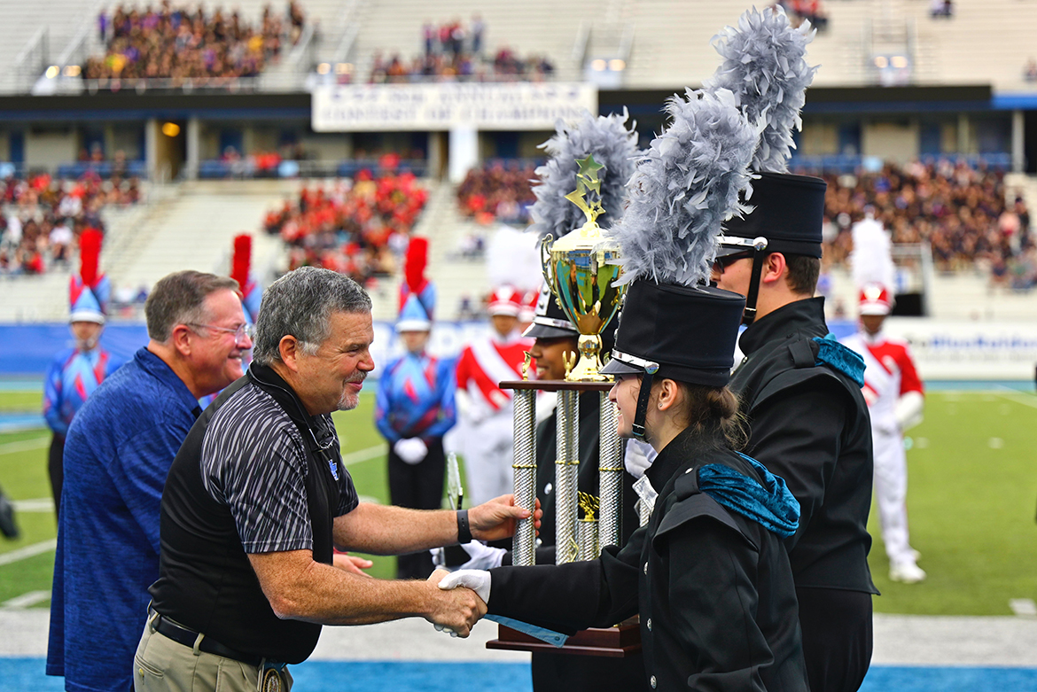 MTSU School of Music professor Reed Thomas, front left, director of bands, congratulates members of the Seigel High School Marching Band of Murfreesboro, Tenn., for their performance at the 58th Contest of Champions held Saturday, Oct. 23, at Floyd Stadium. Shown in the background at left, is Craig Cornish, professor of music and director of athletic bands at MTSU. Seigel captured reserve champion honors at the competition. (MTSU photo by Cat Curtis Murphy)