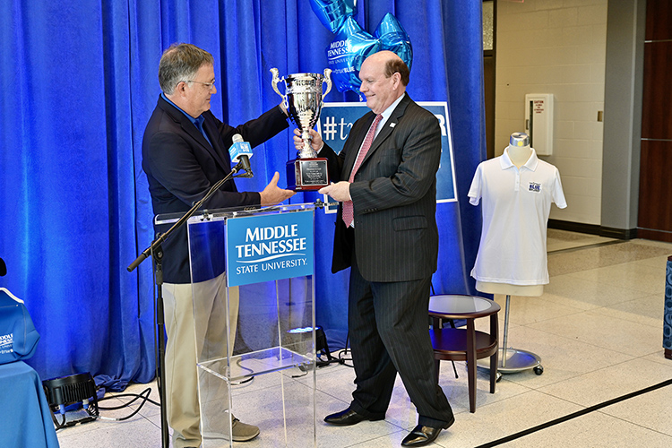 MTSU Provost Mark Byrnes, left, accepts the Provost Cup from Jones College of Business Dean David Urban during the kickoff of the 2021-22 MTSU Employee Charitable Giving Campaign held recently in the atrium of the Cope Administration Building. The Provost Cup is a friendly competition between academic units that is awarded to the college with the highest percentage of employee participation. The Jones College of Business has won the cup for eight straight years. (MTSU photo by Andy Heidt)