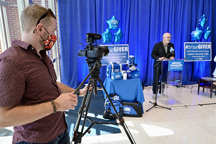 Andrew Oppmann, vice president of marketing and communications and spokesperson for the 2021-22 MTSU Employee Charitable Giving Campaign, gives remarks during the recent campaign kickoff in the atrium of the Cope Administration Building as other campaign volunteers look on. Filming the event, at left, is John Goodwin, strategic communications manager in the Division of Marketing and Communications. (MTSU photo by Andy Heidt)