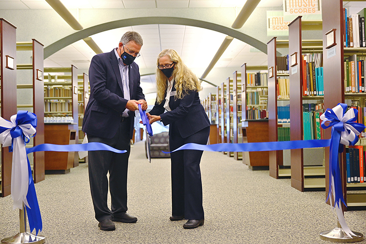MTSU Provost Mark Byrnes and James E. Walker Library Dean Kathleen Schmand officially cut the ribbon Thursday, Oct. 21, to celebrate the library's conversion from the Dewey Decimal System of classifying library materials to the Library of Congress system, which is more commonly used in academia. (MTSU photo by Cat Curtis Murphy)