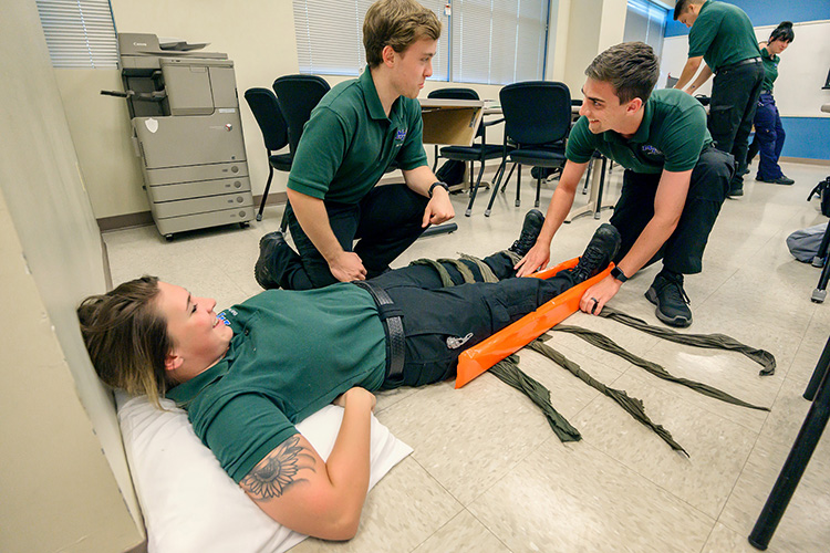 Middle Tennessee State University Advanced EMT students Blake Hutchens, center, and Will Brown share a light-hearted moment with “victim” and classmate Elizabeth Burton during a class in the Miller Education Center. (MTSU photo by Andy Heidt)