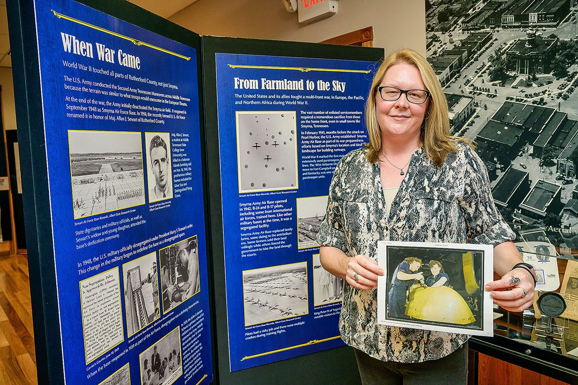 Kira Duke, education specialist at Middle Tennessee State University’s Center for Historic Preservation, holds a Library of Congress digital collection photo of Tennessee women working on a WWII “Vengeance” dive bomber, at the Heritage Center of Murfreesboro and Rutherford County in Murfreesboro, Tenn., on Oct. 13, 2021. MTSU’s center recently landed a $43,000 Library of Congress grant for a research project centered around the impact of WWII on Tennesseans. (MTSU photo by Andy Heidt)