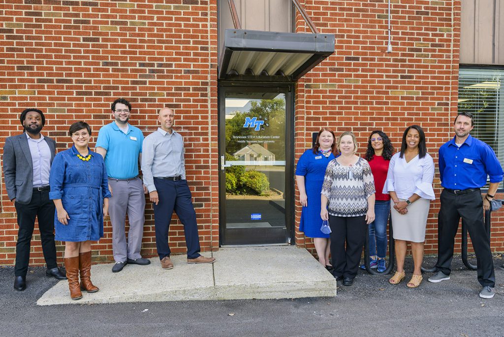 Staff of the Tennessee STEM Education Center at Middle Tennessee State University gather outside their renovated office on campus on Sept. 29, 2021, during their open house event. Standing, from left, are Steven Berryhill, Sarah Gwinn, Josh Reid, Greg Rushton, Mandy Singleton, Sherry Schafer, Shaghayegh Fateh, Andrea Reeder and Grant Gardner. (MTSU photo by Andy Heidt)