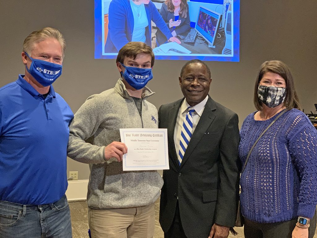 Alex Bolton, second from left, of Henderson, Tenn., holds the MTSU certificate he received after winning a $10,000 scholarship Nov. 4 at the True Blue Tour event at the Jackson Country Club in Jackson, Tenn. He is shown with his father, Patrick Bolton, left, MTSU President Sidney A. McPhee, and his mother, Melissa Bolton. Alex Bolton is a senior at Chester County High School in Henderson. He said he plans to major in history or environmental science, hoping to become a high school history teacher or be a park ranger. (MTSU photo by Randy Weiler)