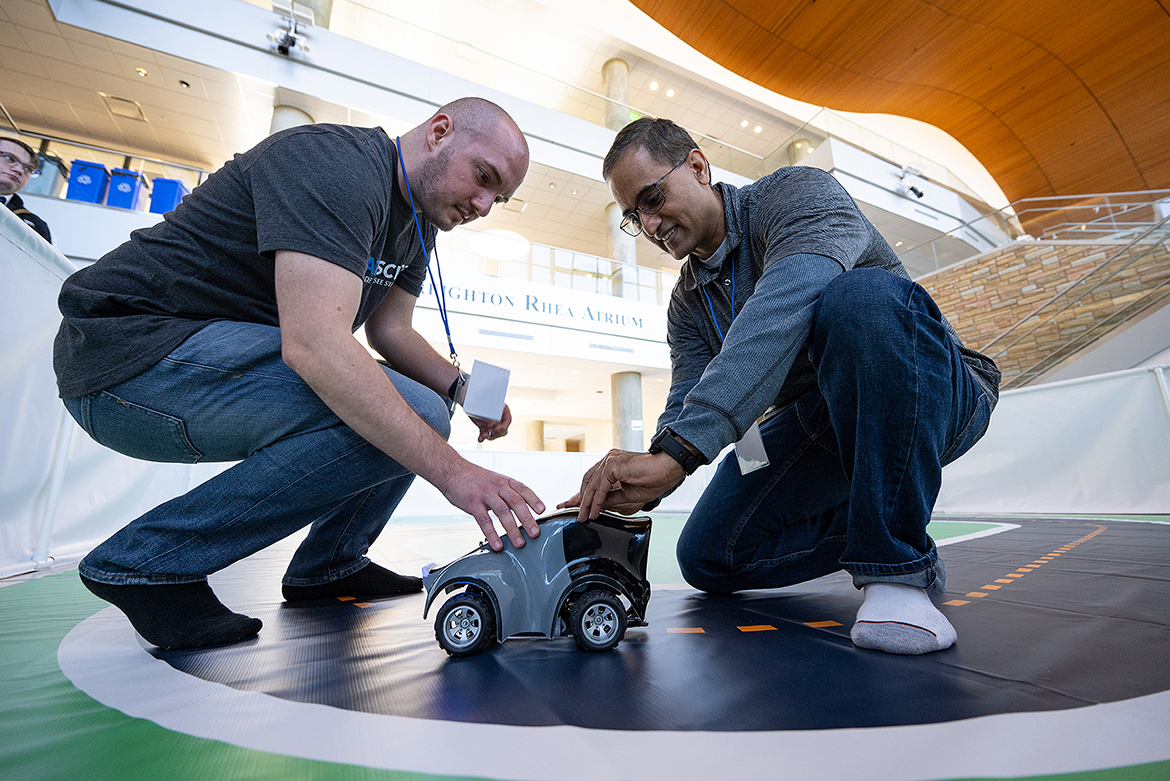 Data scientist Alex Antonison, left, works on a model racer with Vishal Lakhotia, an engineer with Amazon Web Services, during the Nov. 13 “AWS DeepRacer” event held in the MTSU Science Building Atrium. The event, which featured five teams racing autonomous racing models, was sponsored by the MTSU Data Science Institute and Amazon Web Services. (MTSU photo by Cat Curtis Murphy)