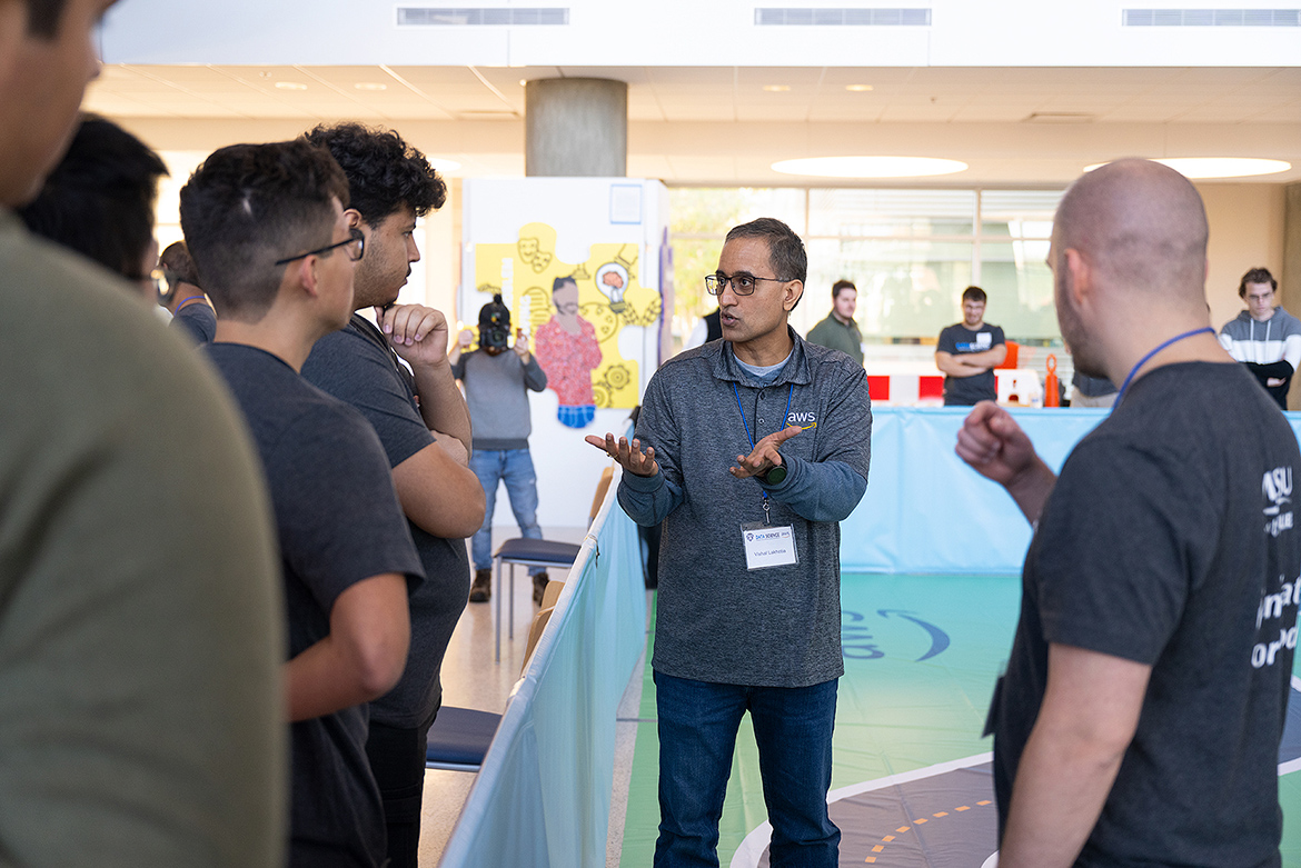Vishal Lakhotia, center, an engineer with Amazon Web Services, speaks with students participating in the Nov. 13 “AWS DeepRacer” event held in the MTSU Science Building Atrium. The event, which featured five teams racing autonomous racing models, was sponsored by the MTSU Data Science Institute and Amazon Web Services. (MTSU photo by Cat Curtis Murphy)