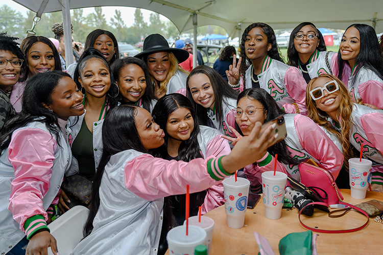 MTSU sorority sisters take a selfie under a tent during the rain that did not dampen spirits for tailgating during the 2021 homecoming activities before the game. This year's main activities will be Friday and Saturday, Oct. 14-15, and other days and times throughout the week. Homecoming Day will be Oct. 15. (MTSU file photo by J. Intintoli)