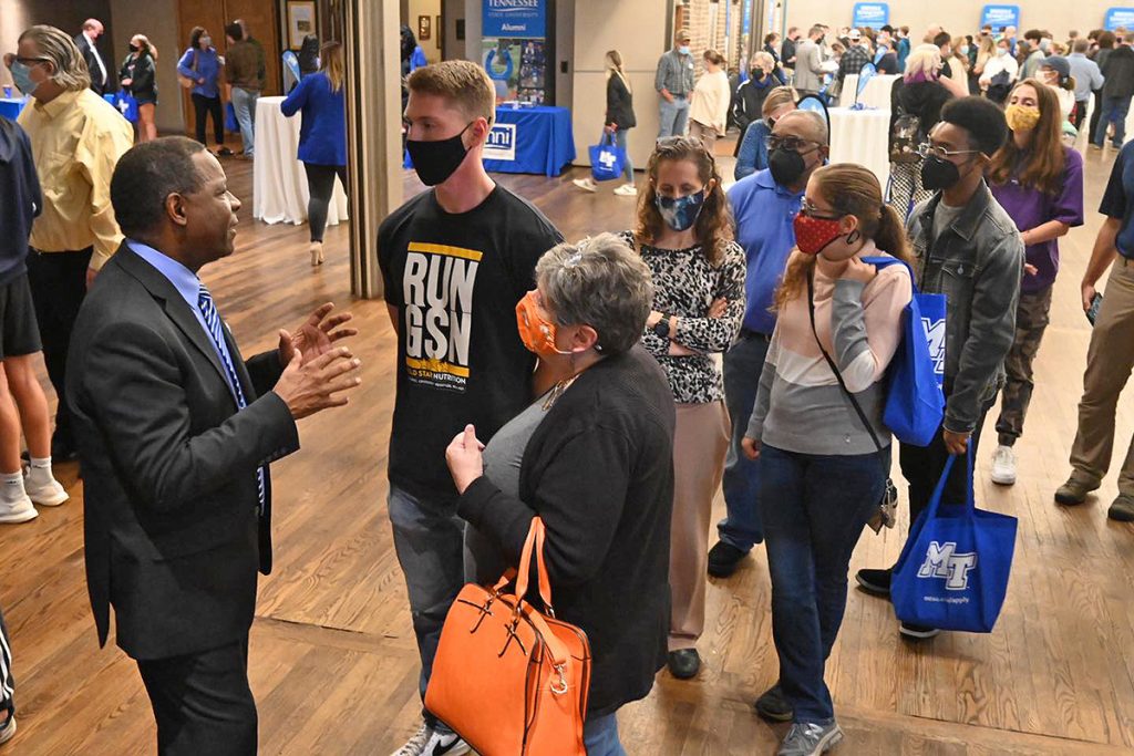 MTSU President Sidney A. McPhee, left, visits with prospective students and their parents in Knoxville, Tenn., answering their questions and selling them on the university’s academic programs and affordability. MTSU recently visited Knoxville, recruiting students for 2022 and beyond as part of the True Blue Tour. (MTSU photo by Andrew Oppmann)