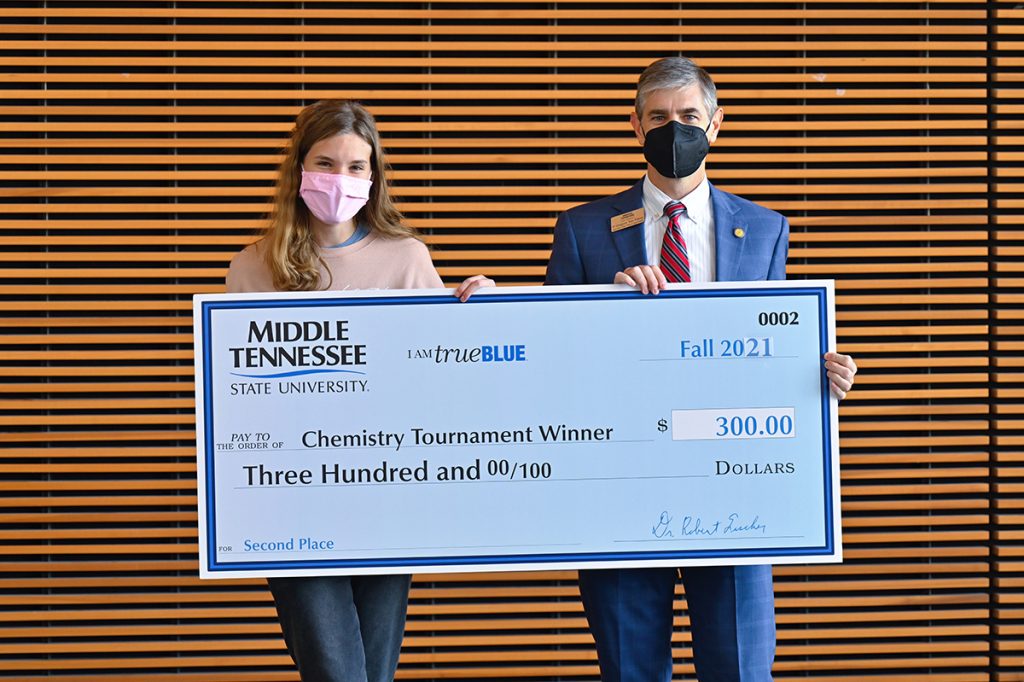 MTSU College of Basic and Applied Sciences interim dean Greg Van Patten, right, presents Hope Clark with a $300 cash prize for finishing second in November in the 2021 Chemistry Scholarship Tournament in the Science Building. She also received a $1,500 scholarship. Clark is a senior at Central Magnet School in Murfreesboro. (MTSU photo by Cat Curtis Murphy)