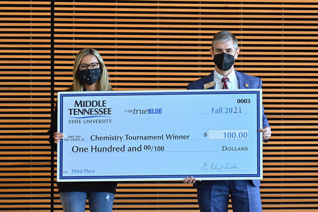 Central Magnet School senior Emma Tellez, left, recently received a $100 cash prize from College of Basic and Applied Sciences interim dean Greg Van Patten for placing third in the recent Chemistry Scholarship Tournament in the Science Building. Tellez also received a $1,000 scholarship. (MTSU photo by Cat Curtis Murphy)