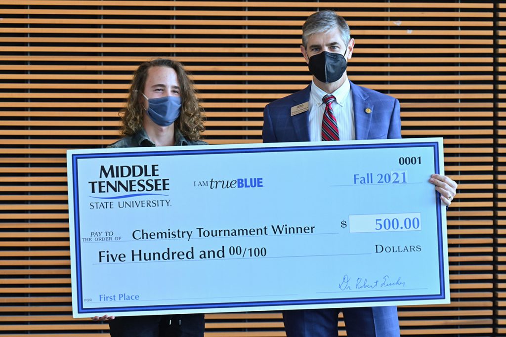Central Magnet School senior Logan Kelley, left, was presented a $500 cash prize by Greg Van Patten, College of Basic and Applied Sciences interim dean, for taking first-place honors in the annual Chemistry Scholarship Tournament held recently in the Science Building. Kelley also received a $2,000 scholarship. (MTSU photo by Cat Curtis Murphy)