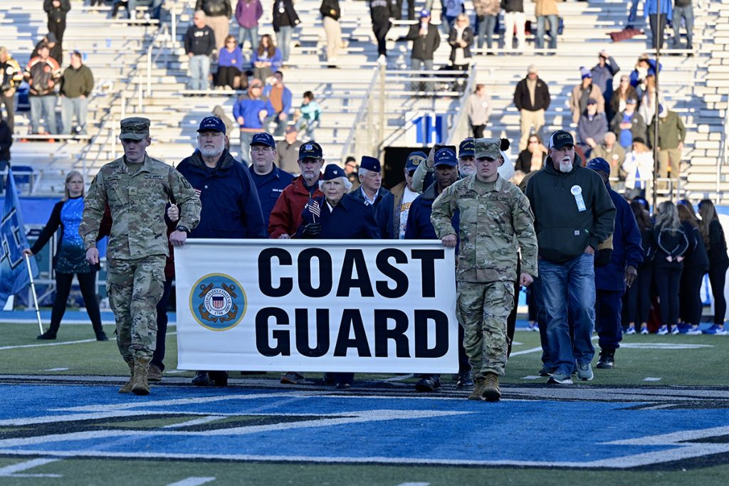 Veterans who served in the U.S. Coast Guard walk behind MTSU ROTC cadets carrying their banner during halftime of the 39th annual Salute to Veterans and Armed Forces game in Floyd Stadium Saturday, Nov. 13. Hundreds of veterans, current service members and their family members were treated to special events throughout the day. (MTSU photo by Andy Heidt)