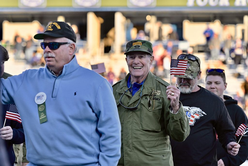 As the MTSU Band of Blue performs their branch’s theme song, MTSU alumnus and Murfreesboro businessman Bud Morris, second from left, walks across Horace Jones Field at halftime with other U.S. Marine veterans in November 2021 during the 39th annual Salute to Armed Forces game activities. MT Athletics and the MTSU Daniels Veterans Center host this year’s 40th Salute game Saturday, Nov. 12, with events starting at 11 a.m. and kickoff for the MTSU-Charlotte game at 2:30 p.m. (MTSU file photo by Andy Heidt)