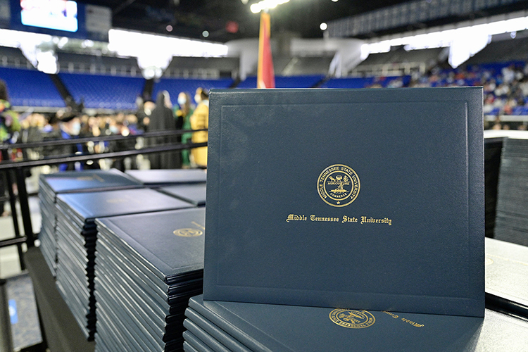 A stack of MTSU diploma covers awaits graduates who'll cross the stage inside Murphy Center for Middle Tennessee State University's fall 2021 commencement in this file photo. More than 1,600 new graduates are expected to receive their degrees in three ceremonies during the dy. (MTSU file photo by Andy Heidt)