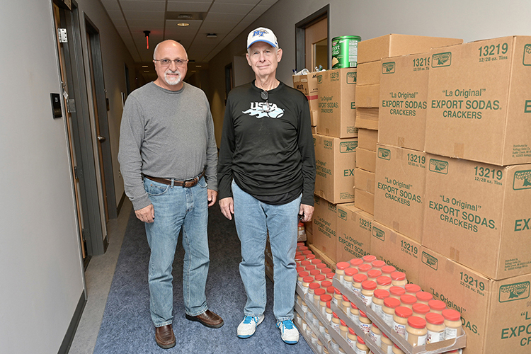 MTSU Trustee Tom Boyd, right, joins Benny Nolen, director of the Joseph's Storehouse nonprofit organization of Lebanon, Tennessee, beside containers of food donated to the MTSU Student Food Pantry in the MT One Stop. (MTSU photo by Andy Heidt).