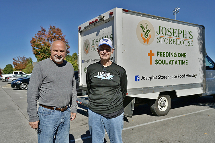 Danny Nolen, left, director of the Joseph's Storehouse food ministry of Lebanon, Tennessee, stands with MTSU Trustee Tom Boyd in front of a truck which delivered 2,000 pounds of food to the MTSU Student Food Pantry. (MTSU photo by Andy Heidt)