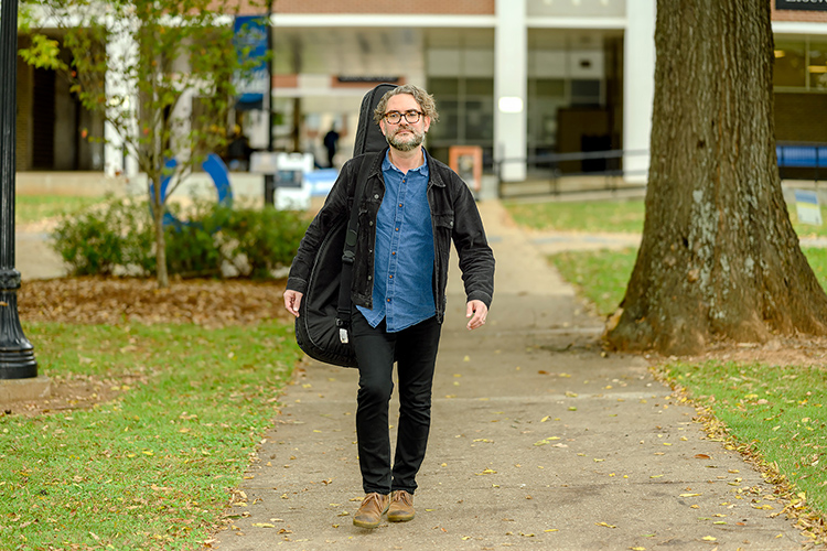 Professional musician and returning student Adam Davis, whose studying jazz in MTSU's Master of Music program, in Walnut Grove with his guitar during the fall 2021 semester. (MTSU photo by J. Intintoli)