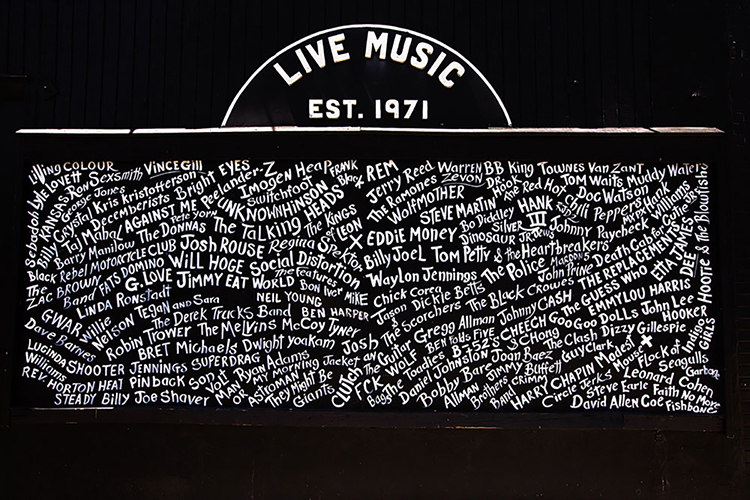 This mural, which is on the wall outside the Exit/In, lists the names of some of the famous acts that have played the venue on Elliston Place in Nashville. They represent a variety of genres, including rock, folk, country, and blues. (Photo by Ryan Green from Exit/In website)