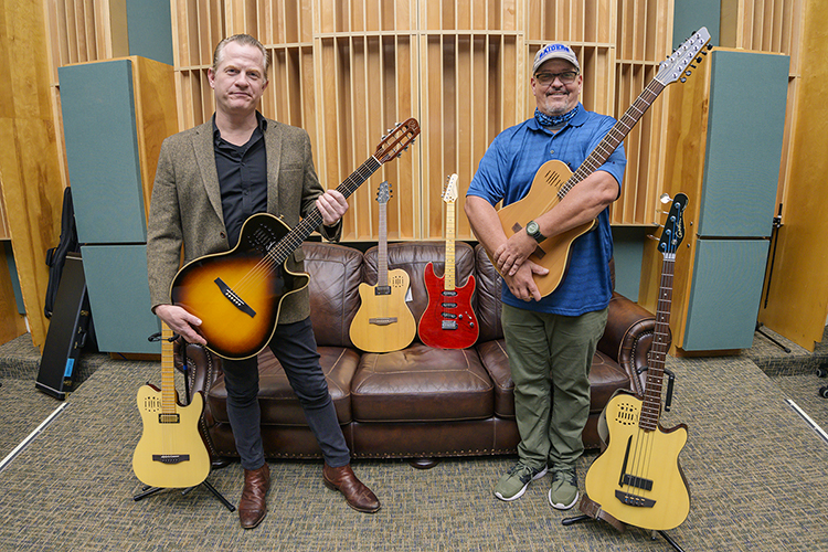 Singer-songwriter and musician Jace Everett, left, the "Nashville ambassador" for Montreal-based luthier Godin Guitars, joins Middle Tennessee State University audio engineering instructor Eben Powell in the Bragg Media and Entertainment Building's Studio B to show some of the eight new electric guitars that the Canadian manufacturer donated to the Department of Recording Industry's Audio Engineering Program Dec. 16. MTSU students will be able to check out the guitars just as they do other equipment needed for their recordings in the College of Media and Entertainment's five studios. (MTSU photo by Andy Heidt)