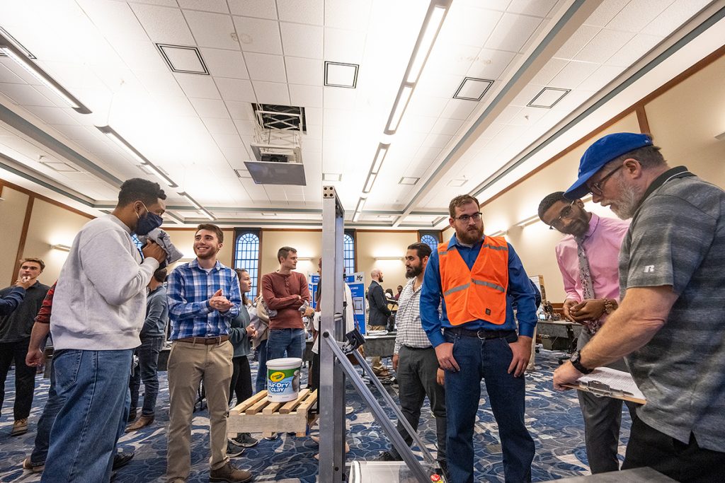 The crowd gathers for the annual MTSU Engineering and Technology Mech-Tech Expo, held in the Ingram Building’s MT Center, showcasing students’ hard work during the fall 2021 semester. Judges, including Rick Taylor, right, take notes on the projects. (MTSU photo by Cat Curtis Murphy)