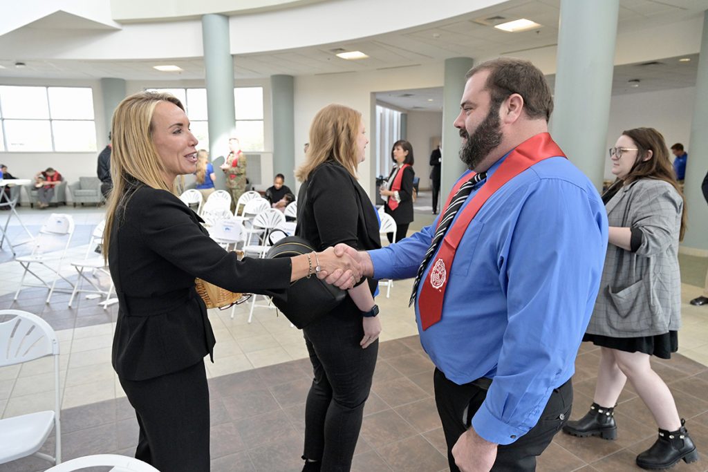 Hilary Miller, left, director of the MTSU Charlie and Hazel Daniels Veterans and Military Family Center, congratulates Anthony Bond for completing the journey to graduate from the university. Bond was one of 30 graduating veterans participating in the fall 2021 stole ceremony Wednesday, Dec. 1, in the Miller Education Center second-floor atrium. The event was sponsored by Amazon Military. MTSU’s commencement will be Saturday, Dec. 11, in Murphy Center. (MTSU photo by Andy Heidt)